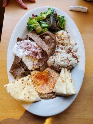 Gyro Plate with Salad, Grape Leaf, rice, Hummus and Pita bread, lots of gyro meat and Tzatziki sauce.