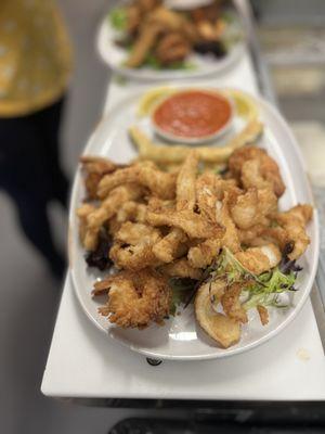 Fritto Misto - one of our popular starters with fried calamari, shrimp, zucchini, served with Marinara sauce.