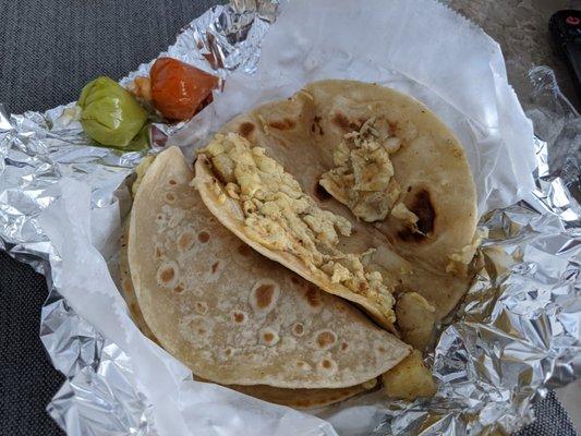 Potato and egg tacos with the accompanying hot sauces