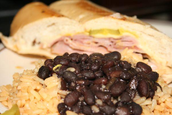 Cuban sandwich with black beans and rice.