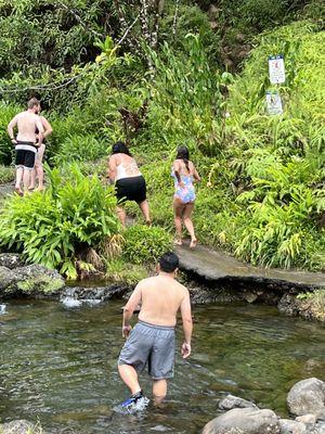 walking to go for a dip in the waterfall