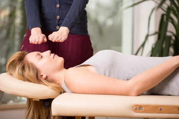 A Reiki session - face up or down on a therapy table, or seated upright in a chair, fully-clothed.