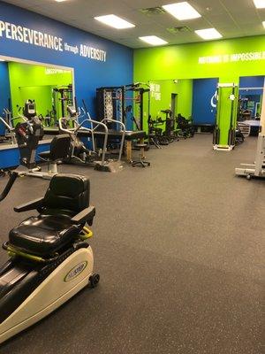 Strengthening, cardio, and weight bearing equipment on the interior of the gym.