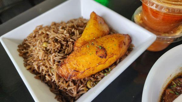 Djon djon rice with fried plantain. The rice was very dry and had the taste and texture of old microwaved/reheated rice