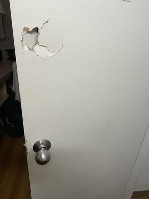 Hole someone punched in bathroom door