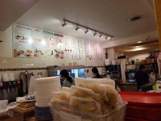 Behind the counter you can see the worker taking the egg rolls and Crab Rangoon out of the metal bucket