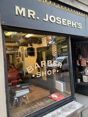 Storefront with a classic barber pole.