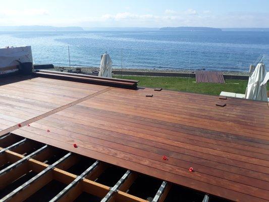 Ipe deck with ocean view, mid installation.  Hidden channel clip fastener system for clean deck surface.