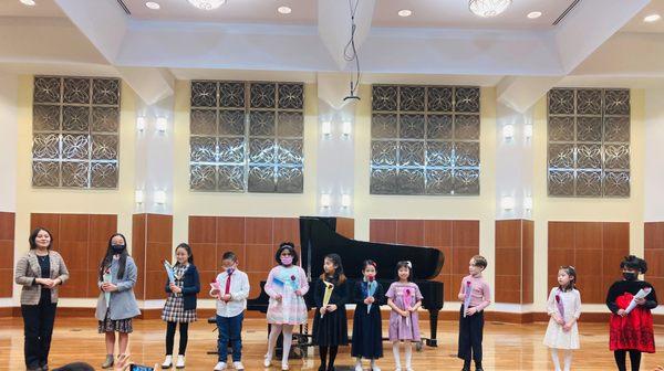 Young piano students take a bow after their winter recital.