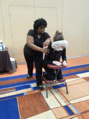 Client enjoy Amira's elbow at a chair massage event.