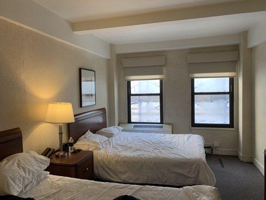 Dated furniture, peeling ceiling, old windows