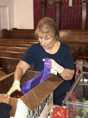 Ursula packing vegetables.