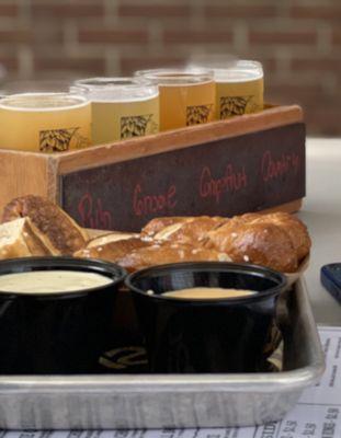 pretzel bread with mustard dip, flight of beer