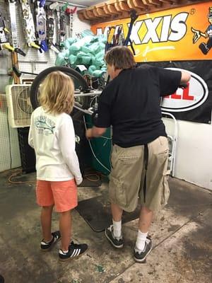 Our young bike mechanic in training. Joe visiting from from Austin Texas.