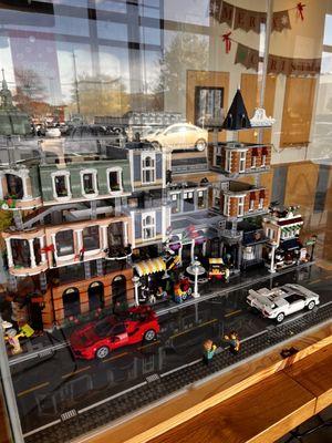 Adorable LEGO village, showcased in a central case