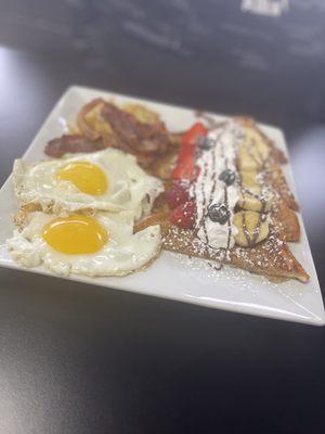 Sunny side up eggs, crispy bacon, hashbrown and strawberry banana French toast