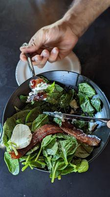 Salade de Chevre Chaud - mixed green salad tossed in a citrus dressing topped with fresh goat cheese, toast, bacon and medjool dates