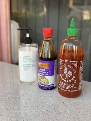 Hand sanitizer and sauces on each table