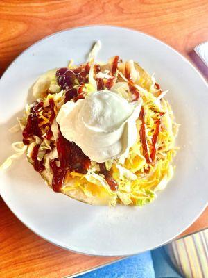 BBQ pulled pork on a perfectly cooked bake potato ! YUM !