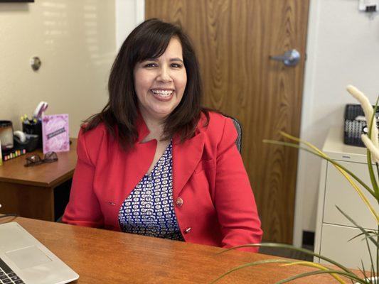 Realtor extraordinaire, Lupe Martinez, is all smiles at the office taking a brief break from her showings.