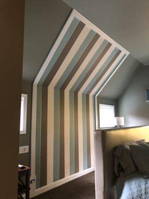 Wallpaper hung behind bed in master bedroom