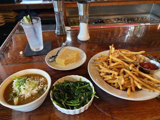 Gumbo, sautéed spinach, fries and corn bread.