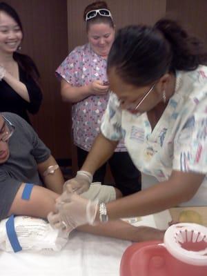 Hands-on blood drawing and venipuncture practice.