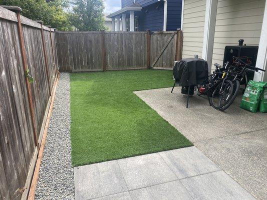 Small backyard renovation with turf and patio.