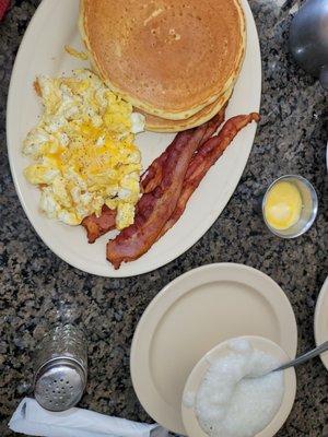 2 hotcakes , 2 eggs ,  2 bacon ,  added side of grits