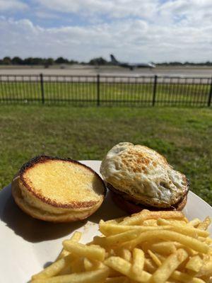 Cheeseburger with added egg, on a toasted buttered bun.