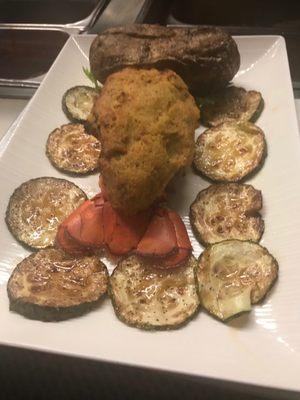 Main lobster tail crabmeat stuffing baked potato zucchini lobster sauce