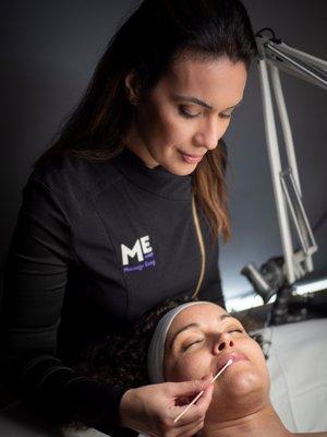 Estheticians perform custom facial treatments including exfoliating lip treatments