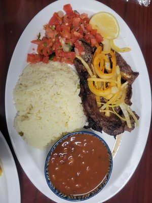 Carne asada steak with rice and beans