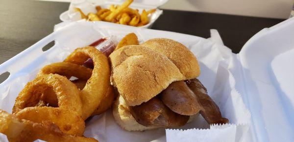 Double Johnsonville Brat with onion rings and fries