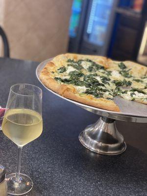 Amazing white pizza with fresh spinach.