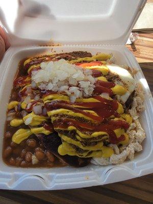 Plate with baked beans, two white hots, mac salad and hamburger with meat sauce.