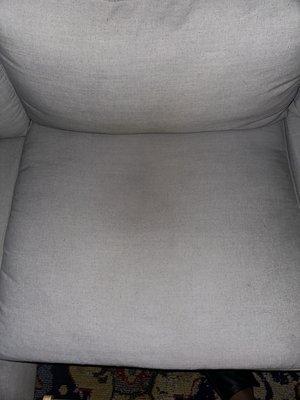 This is the sofa cushion after being deep cleaned and washed. You can see how dingy it is.