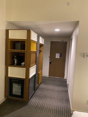 Entryway, storage, coffee station, and mini fridge