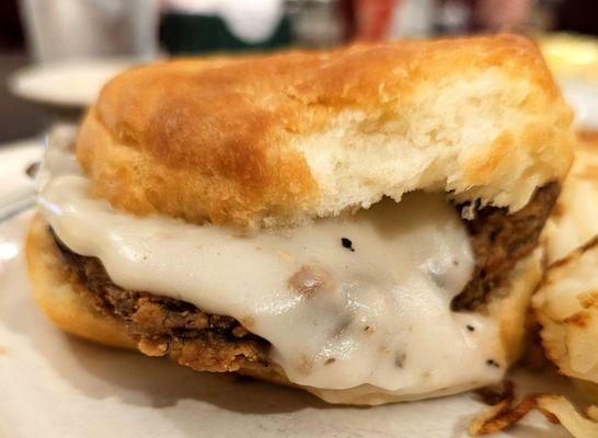 Chicken fried steak on a biscuit with gravy