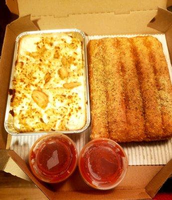 Chicken alfredo pasta & breadsticks.