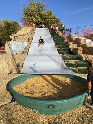 Huge hay bale slide into corn!