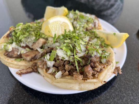 Left: carnitas taco. Front: carne asada taco.