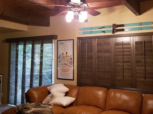 Stained wood shutters and coordinating sliding panels with matching wood cornice. This job turned out so beautiful!