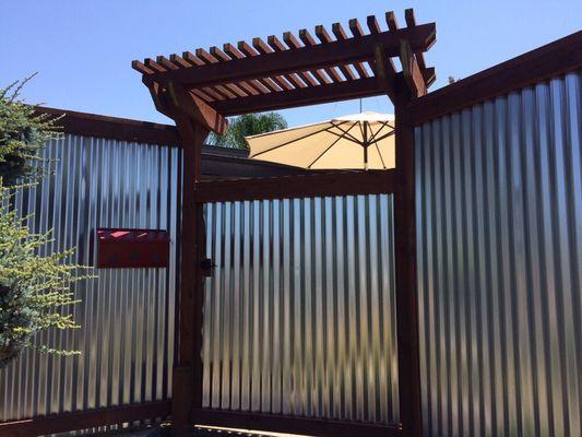 Arbor on the corrugated fence