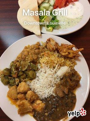 Lunch buffet: pokora, chicken biryani, basmati rice, lamb Masala, daal, chicken tikka Masala, okra, chana, and accompaniments.