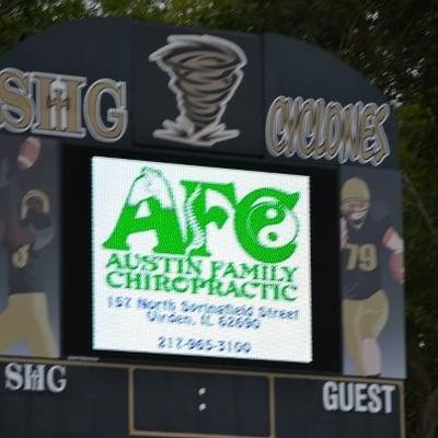 The Austin Family Chiropractic logo on the Jumbotron at SHG Stadium.