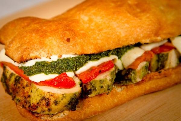 The Pesto Chicken with marinated organic chicken breast, pesto Genovese, fire-roasted peppers, fresh mozz, lemon aioli