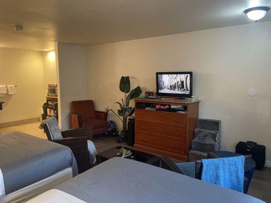 Room with small kitchen and flat screen tv