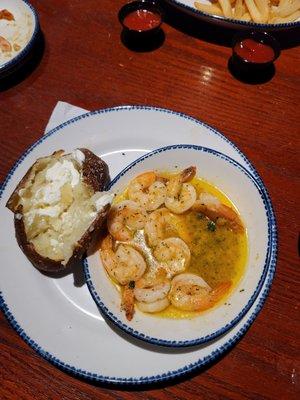 Lunch portion shrimp scampi. My absolute FAVORITE.  Baked potato with butter and sour cream.