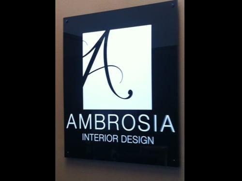 custom lobby sign of matte black acrylic and digital print logo with matching matte black stand offs